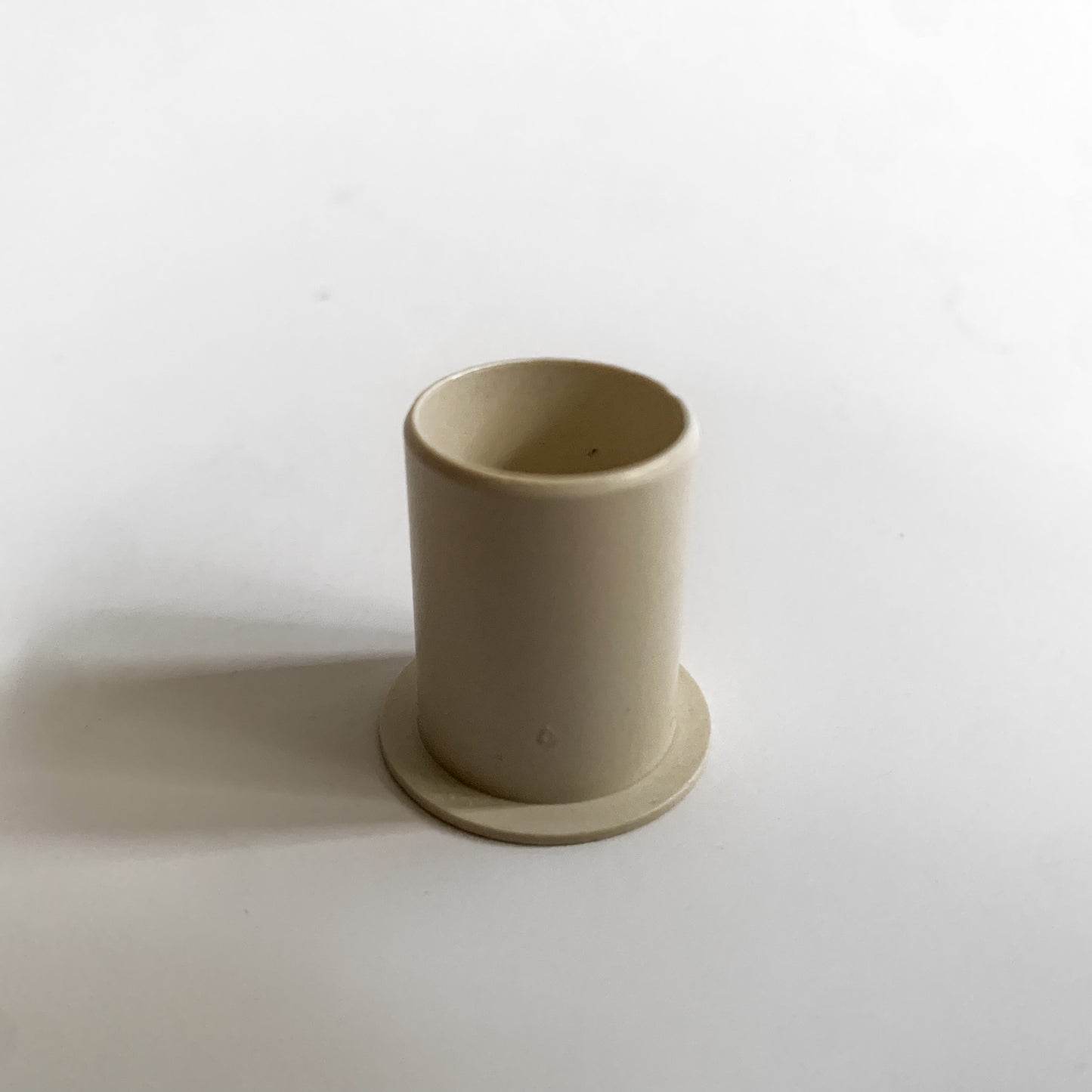 Rotation belt bushing for under camera timing belt.